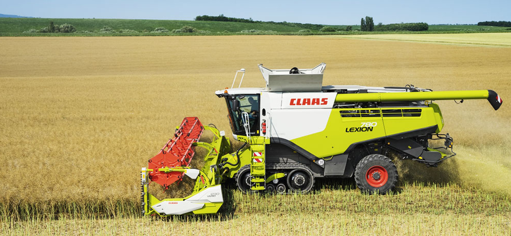 A CLAAS combine harvester at work in a field.